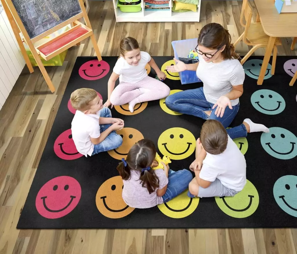 Colorful Rainbow Smileys Classroom Rug by Flagship Carpets creates an engaging learning space, offering vibrant designs perfect for educational environments.