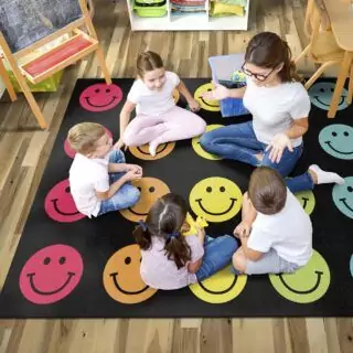 Colorful Rainbow Smileys Classroom Rug by Flagship Carpets creates an engaging learning space, offering vibrant designs perfect for educational environments.