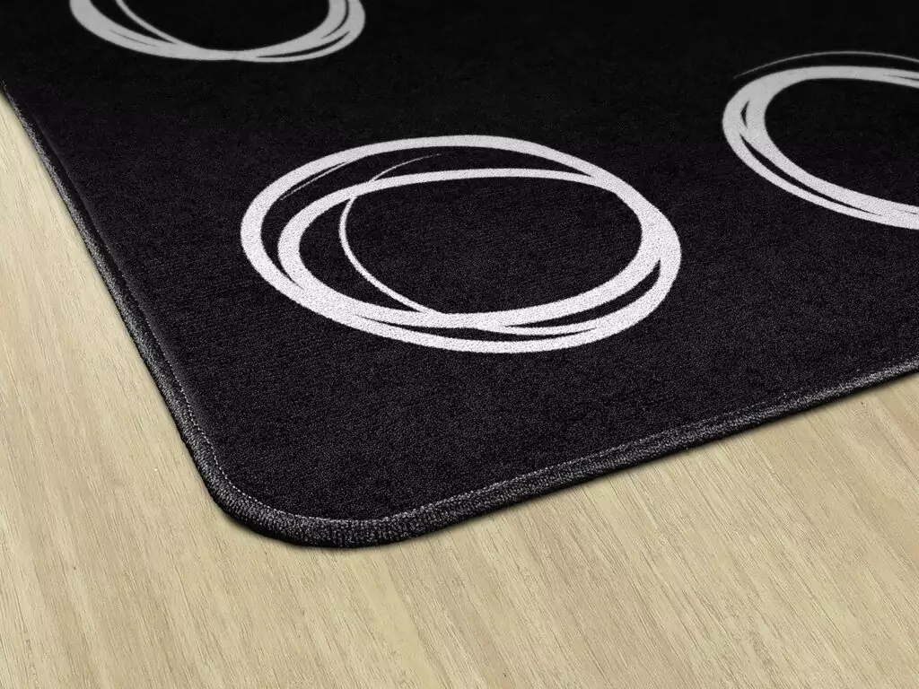 Vibrant circular sampler rug enhancing kids' educational spaces, fosters creativity and learning, perfect for stimulating classroom design.