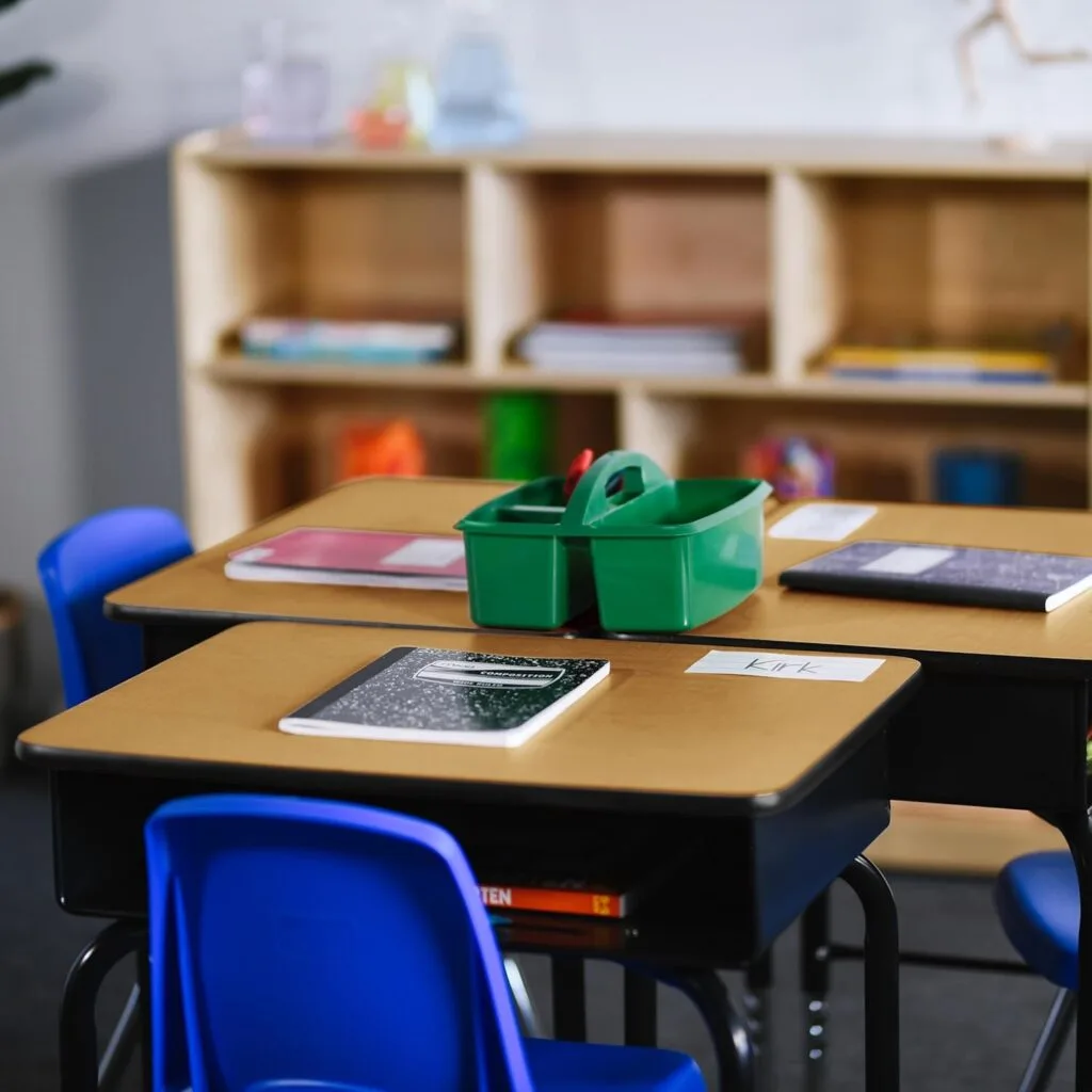 Modern adjustable desk featuring metal storage compartments and an oak finish, ideal for enhancing classroom furniture with functionality and style.