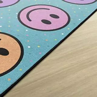 Vibrant educational seating rug designed for kids' classrooms, featuring colorful smiley faces to enhance learning and create an inviting play area.