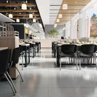 Ergonomic Hercules classroom chairs feature contoured seats and perforated backs, enhancing comfort and style in a modern educational setting.