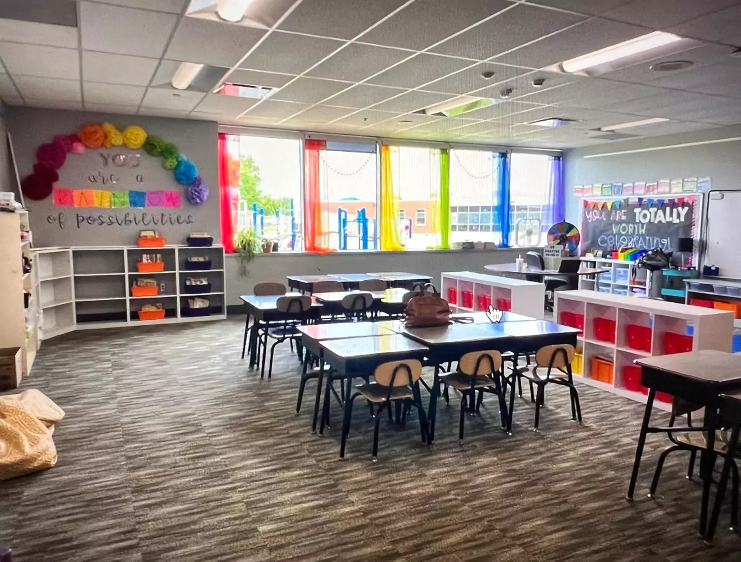 Colorful sheer rainbow curtains ideal for enhancing classroom and nursery backdrops, offering a lively and inviting atmosphere for young learners.