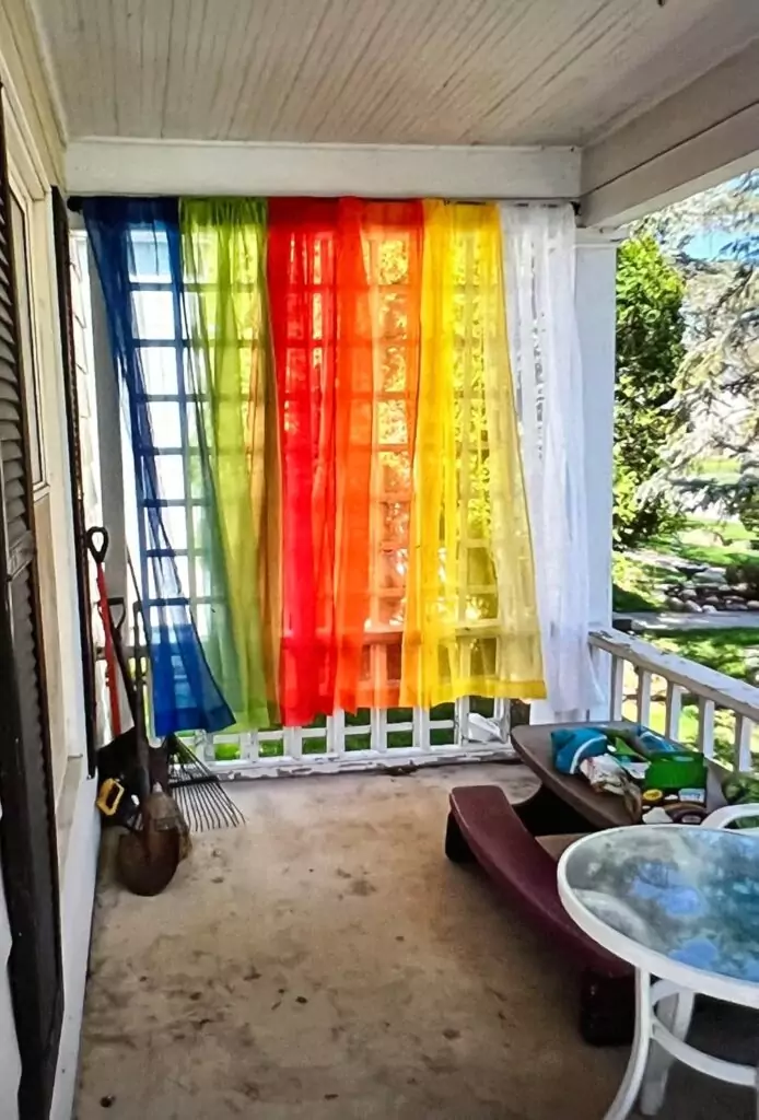 Bright and colorful rainbow curtains add a playful touch to a classroom, serving as an educational decor backdrop. Ideal for inspiring creativity and learning.