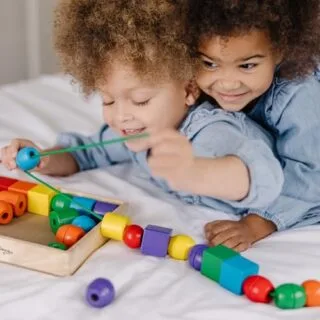 Colorful wooden bead lacing set for toddlers by Melissa & Doug enhances learning and play, strengthening fine motor skills and creativity.