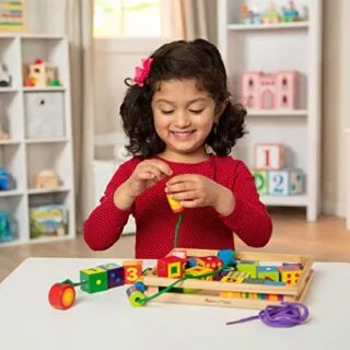 Melissa & Doug wooden lacing beads toy features 27 colorful beads and 2 laces, promoting creativity and fine motor skills development in children.
