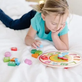 Wooden Shape Sorting Clock by Melissa & Doug: An educational toy featuring colorful numbers to teach time and shapes, promoting learning and fun.