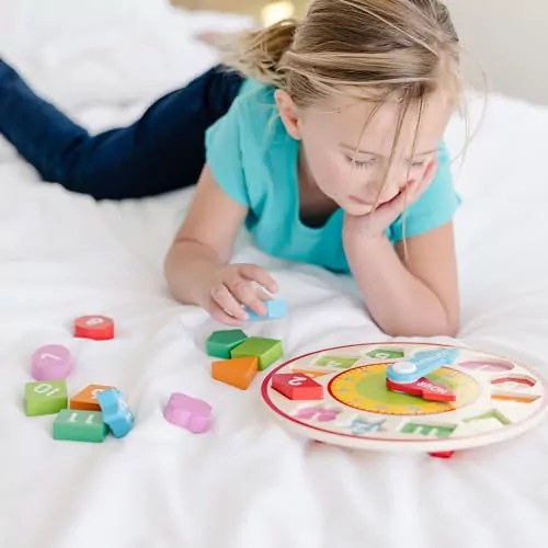 Wooden Shape Sorting Clock by Melissa & Doug: An educational toy featuring colorful numbers to teach time and shapes, promoting learning and fun.